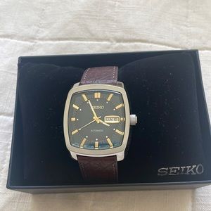 Seiko watch with men’s strap. Comes with box, brand new.